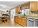 Open kitchen featuring wood cabinets, granite countertops and stainless steel appliances overlooking the dining room at 67 Regency Oaks Dr, Summerville, SC 29485