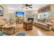 Well-lit living room with hardwood floors, a fireplace, and comfortable seating arrangements at 67 Regency Oaks Dr, Summerville, SC 29485