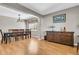 Open-concept living room showcasing hardwood flooring, an elegant dining area, and tasteful decor at 67 Regency Oaks Dr, Summerville, SC 29485