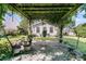 Lush backyard patio featuring climbing plants, a stone tile base, and wrought-iron furniture at 67 Regency Oaks Dr, Summerville, SC 29485