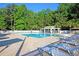 Community pool featuring lounge chairs, tables, and shaded pergola at 67 Regency Oaks Dr, Summerville, SC 29485