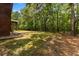 Large grassy backyard with wooded area, and the back side of the house at 6840 Early Jersey Rd, Meggett, SC 29449