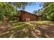 Exterior view of home showcasing wooden siding, a screened porch, and spacious backyard at 6840 Early Jersey Rd, Meggett, SC 29449