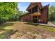 Home exterior featuring a screened in porch, wooden siding and large yard at 6840 Early Jersey Rd, Meggett, SC 29449