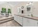 Bright bathroom with tile flooring, double sink vanity, and natural light from large windows at 6840 Early Jersey Rd, Meggett, SC 29449