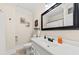 Bathroom with a framed mirror, toilet, sink, and a shower with a white curtain at 6840 Early Jersey Rd, Meggett, SC 29449