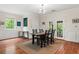 Bright dining room with hardwood floors, wainscoting, and a view of the yard at 6840 Early Jersey Rd, Meggett, SC 29449