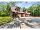 Inviting home featuring a three car garage, beautiful landscaping, and a welcoming front porch at 6840 Early Jersey Rd, Meggett, SC 29449