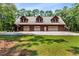 Spacious three-car garage with upper level framed by lush greenery at 6840 Early Jersey Rd, Meggett, SC 29449
