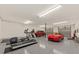 Spacious garage featuring a car, treadmill, and overhead garage doors at 6840 Early Jersey Rd, Meggett, SC 29449