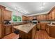 Bright kitchen featuring a large island, custom cabinets, and a window above a sink at 6840 Early Jersey Rd, Meggett, SC 29449