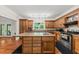 Kitchen showcases wooden cabinets and a large island with seating, adjacent to a dining area at 6840 Early Jersey Rd, Meggett, SC 29449