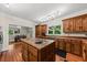 Renovated kitchen features custom wood cabinets and an island with a sink; open to dining at 6840 Early Jersey Rd, Meggett, SC 29449