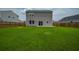 Exterior view of home featuring a spacious backyard, privacy fence, and sliding glass door at 716 Mcroy St, Moncks Corner, SC 29461