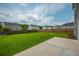 Extensive backyard featuring lush green lawn, privacy fence, and concrete patio at 716 Mcroy St, Moncks Corner, SC 29461