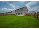 Expansive backyard with lush green grass, wood fence, and a sliding glass door at 716 Mcroy St, Moncks Corner, SC 29461