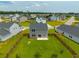 Aerial view of backyard featuring a large green lawn enclosed by a wooden fence in a residential neighborhood at 716 Mcroy St, Moncks Corner, SC 29461