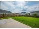 Large backyard featuring a concrete patio, lush green grass, and a wood fence at 716 Mcroy St, Moncks Corner, SC 29461