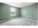 Cozy bedroom with stylish green walls, a window providing natural light, and soft carpet flooring at 716 Mcroy St, Moncks Corner, SC 29461