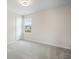 Carpeted bedroom featuring a large window with blinds, allowing ample natural light at 716 Mcroy St, Moncks Corner, SC 29461