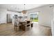 Bright dining area with modern lighting, wood floors, and sliding glass doors to the backyard at 716 Mcroy St, Moncks Corner, SC 29461