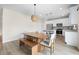 Open dining area with modern lighting, a dining table, and an adjacent kitchen with stainless steel appliances at 716 Mcroy St, Moncks Corner, SC 29461