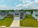 Attractive two-story home with a green lawn and two-car garage at 716 Mcroy St, Moncks Corner, SC 29461