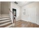 Spacious foyer featuring wood-look flooring, staircase, and a view into the powder room at 716 Mcroy St, Moncks Corner, SC 29461