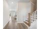 Bright hallway with wood floors, white walls, staircase, and view into the living room at 716 Mcroy St, Moncks Corner, SC 29461