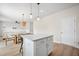 Open-concept kitchen featuring a center island, pendant lighting, and seamless transition to the dining and living area at 716 Mcroy St, Moncks Corner, SC 29461