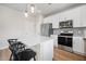 Modern kitchen boasts stainless steel appliances, a center island with barstool seating, and stylish pendant lighting at 716 Mcroy St, Moncks Corner, SC 29461