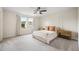 Spacious main bedroom featuring neutral tones, a ceiling fan, large windows, and decorative wall trim at 716 Mcroy St, Moncks Corner, SC 29461