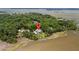 Aerial view of home showcasing its location and proximity to the water surrounded by lush green trees at 8964 Palmetto Rd, Edisto Island, SC 29438