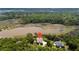 Aerial view of a community of waterfront homes nestled amongst mature trees at 8964 Palmetto Rd, Edisto Island, SC 29438