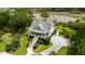 Aerial view of a two-story home with covered porch and a waterfront lot at 8964 Palmetto Rd, Edisto Island, SC 29438