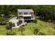 Aerial view of a charming two-story home with multiple decks and a lush green yard at 8964 Palmetto Rd, Edisto Island, SC 29438