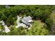 Stunning coastal home with a lush, green lawn, mature trees, and scenic marsh views from the top deck at 8964 Palmetto Rd, Edisto Island, SC 29438