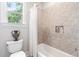 Cozy bathroom with a shower-tub combo and a decorative vase on the toilet at 8964 Palmetto Rd, Edisto Island, SC 29438