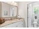 Well-lit bathroom featuring a granite countertop and a stylish mirror at 8964 Palmetto Rd, Edisto Island, SC 29438