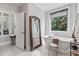 Bright bathroom with large window, marble floors, a claw foot tub, and chrome fixtures at 8964 Palmetto Rd, Edisto Island, SC 29438