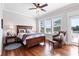 Comfortable bedroom with hardwood floors, large windows, and access to a balcony at 8964 Palmetto Rd, Edisto Island, SC 29438
