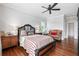 Spacious bedroom features hardwood floors, a ceiling fan, and traditional furnishings at 8964 Palmetto Rd, Edisto Island, SC 29438