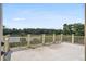 Spacious deck with white railings overlooking the water and lush trees at 8964 Palmetto Rd, Edisto Island, SC 29438