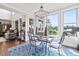 Elegant dining area with large windows, stylish chandelier, and comfortable seating at 8964 Palmetto Rd, Edisto Island, SC 29438
