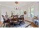 Formal dining room with chandelier, elegant furnishings, and natural light at 8964 Palmetto Rd, Edisto Island, SC 29438