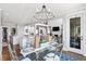 Open-concept dining area, connected to kitchen and living room, with a glass table and stylish decor at 8964 Palmetto Rd, Edisto Island, SC 29438