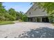 Wide gravel driveway of this home with a look at the ground level parking and storage space at 8964 Palmetto Rd, Edisto Island, SC 29438