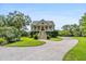 Two-story home with a charming front porch and circular driveway at 8964 Palmetto Rd, Edisto Island, SC 29438