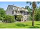 Charming coastal home with multiple decks, screened porch, and lush landscaping at 8964 Palmetto Rd, Edisto Island, SC 29438