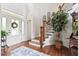 Welcoming foyer with a staircase, elegant rug, and natural light at 8964 Palmetto Rd, Edisto Island, SC 29438